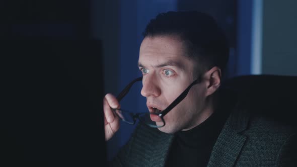 Businessman Shocked and Surprised While Working at Computer Laptop Late at Night