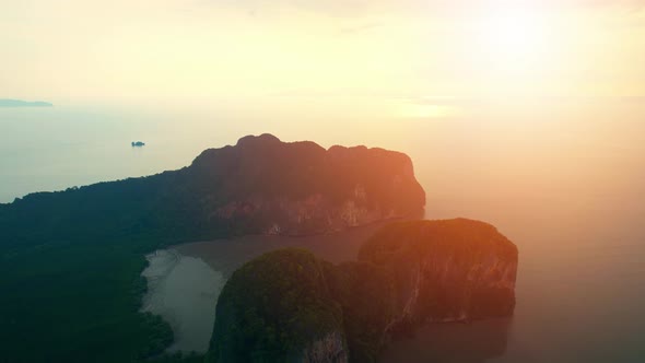 Aerial view over the coast, mountains and beaches during beautiful sunsets alt