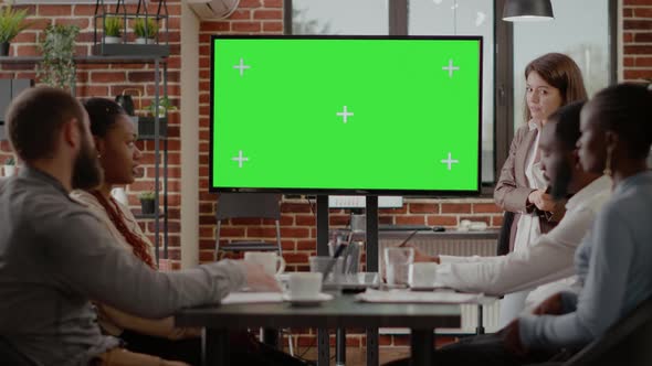 Workmates Using Isolated Green Screen on Monitor alt