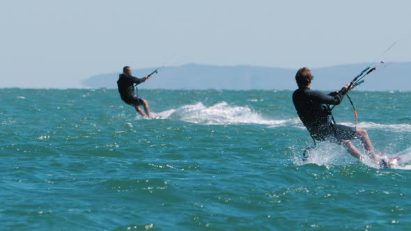 Kiters Ride Waves on Twintip alt