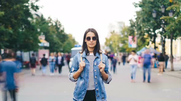 Time-lapse Portrait of Attractive Brunette in Sunglasses Standing in the Street By Herself and alt