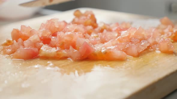 Cutting tomatoes on smaller pieces and arranging  with knife close-up 4K 2160p UltraHD footage - Fre alt