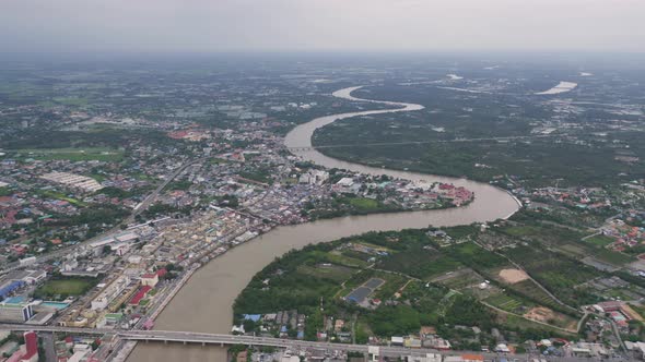 Aerial view of buildings with curve of Chao Phraya River. Cha Choeng Sao skyline near Bangkok alt