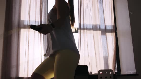 Teenage Girl Exercising with Jump Rope at Home