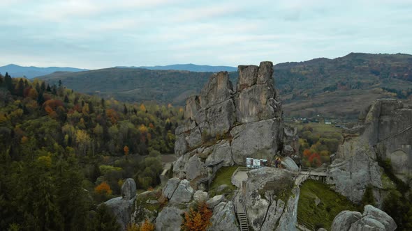 Aerial Top Down View Newly Made Asphalt Road Between Hills Green and Orange Woods alt