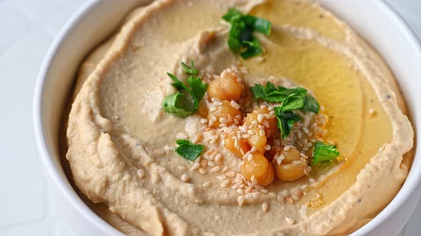 hummus with sesame and olive oil close up. Healthy vegan food. Hummus rotation. Vegetarian dish