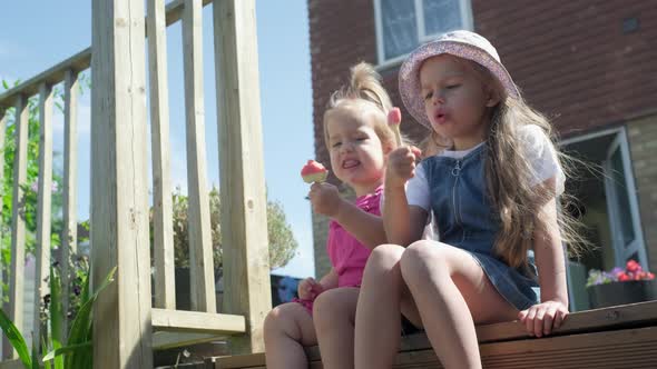 Two Sisters Children Enjoys Delicious Ice Cream Cone alt