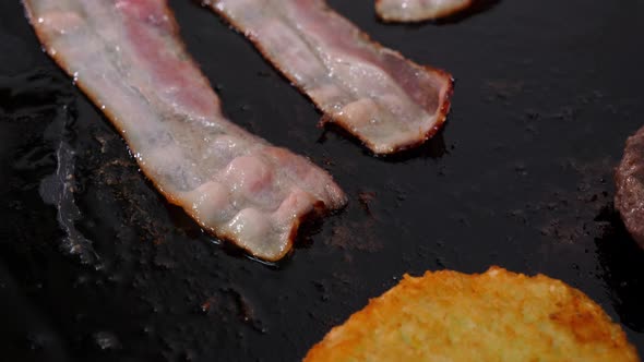 Slices of Bacon with Meat Patty for a Burger Fries on the Grill