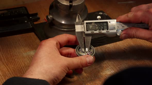 Jeweler Measures Zirconium Gemstones alt