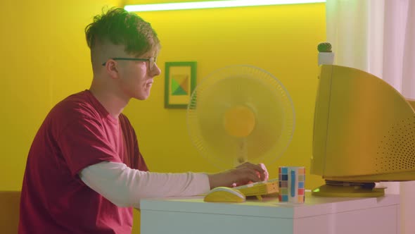 Young Man Is Typing On Retro Computer In Yellow Designed Style