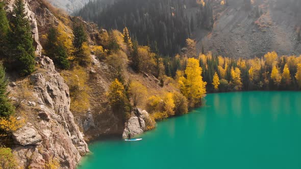 Man Is Paddling on Sup Board in the Mountain Lake alt