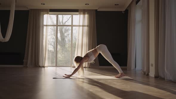 Healthy Woman Exercising at Home Practicing Yoga Poses in Room Enjoying Morning Fitness Workout alt