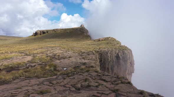 Stunning Aerial View of Rocky Edge of the Cliff Among Clouds