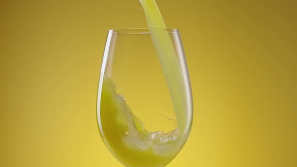 A Stream of Freshly Squeezed Natural Orange Juice Poured Into a Glass alt