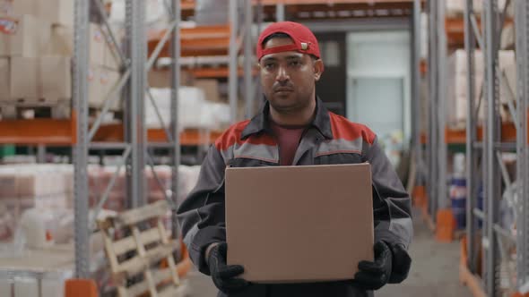 Serious Stockroom Worker With Carton Box alt