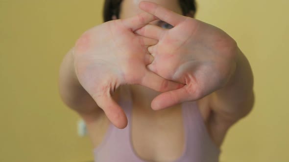 Young woman stretching arms. Fitness female doing warmup exercise, focus on hands.