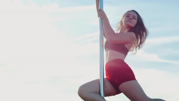 Pole Dance on Nature - Young Woman in Sports Clothes Dancing alt