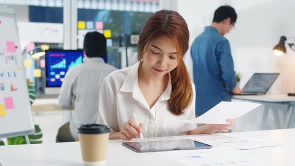 Asia young businesswoman smart writing and using pen with digital tablet computer.