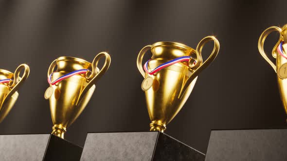 An endless row of cups and medals for winners. Trophies for sports champions. alt