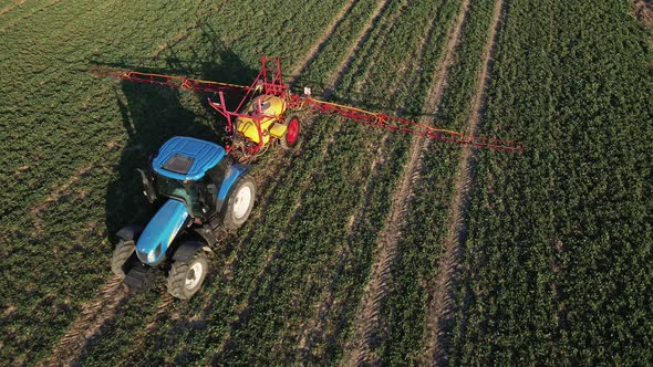 Tractor Spray Fertilizer on Agricultural Field Aerial View alt
