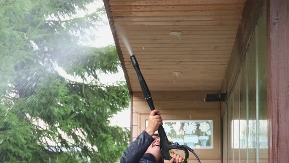 Man Cleaning Walls and Floor with High Pressure Power Washer