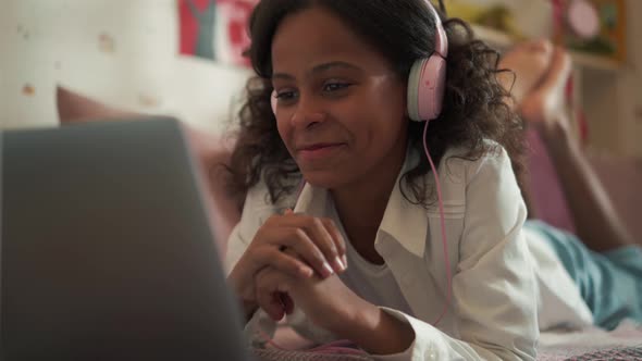 Happy girl watching something on laptop alt