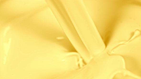 Super Slow Motion Shot of Pouring and Splashing Vanilla Milk at 1000Fps. alt