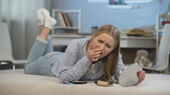 Young Lady Lying on Bed, Worried About Her Skin Problems, Age-Related Changes alt