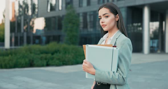 A Smiling Pretty Successful Girl Running Her Own Company Manager Boss is Standing Next to Glass alt