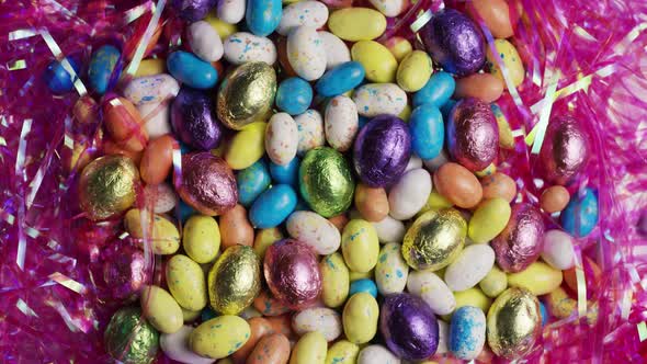 Rotating shot of colorful Easter candies on a bed of easter grass alt