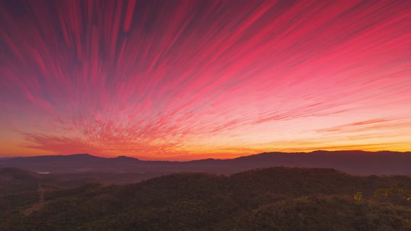 Beautiful Long exposure of morning sky cloudscape over fertile forest mountains.