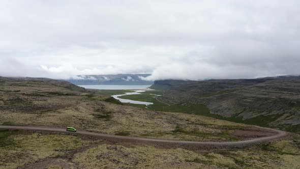 Van Driving In The Downhill Road Towards Fjords In Westfjord In Iceland. - aerial alt