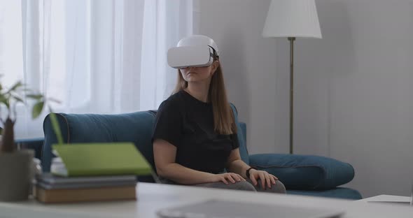Technology of Virtual Reality Today Woman with HMDdisplay on Head in Apartment Looking Around alt