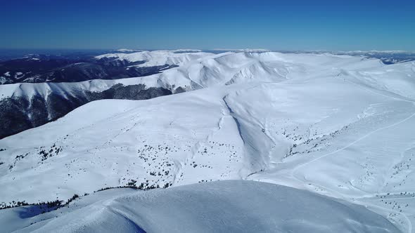 Flight Over the Turquoise Snowy Mountains Illuminated By the Day Sun alt