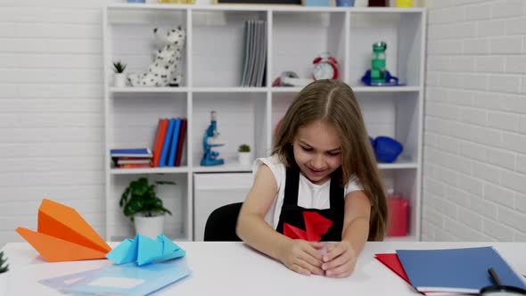 Happy Child Having Fun Playing with Paper Plane at School Lesson in Classroom Childhood