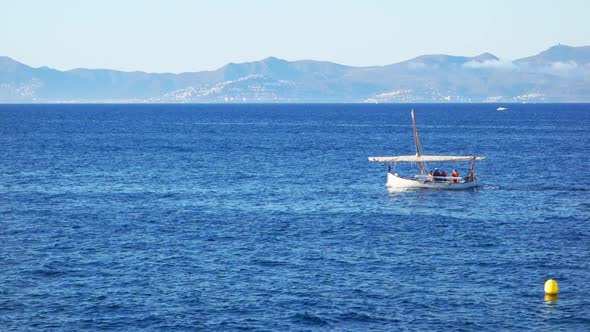 Traditional Mediterranean Vessel Named Llagut Sailing in the Wind Through the Waves alt