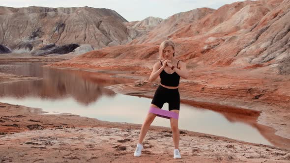 Woman working out on lifeless dried locality