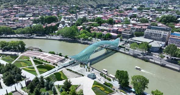Aerial view of Tbilisi city central park and Bridge of Peace. Beautiful cityscape of old Tbilisi at alt