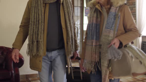 Elderly Caucasian Couple Checking into Hotel alt