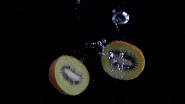 Kiwi Falling into Water Super Slowmotion, Black Background, lots of Air Bubbles, 4k240fps alt