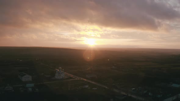 Church in a Small Town. Epic Sunset and Smooth Camera Movement - Aerial View