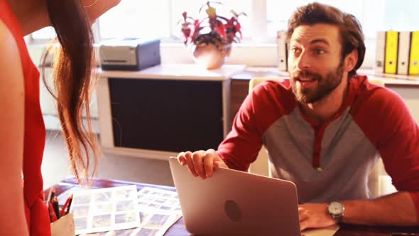 Graphic designers interacting with each other alt