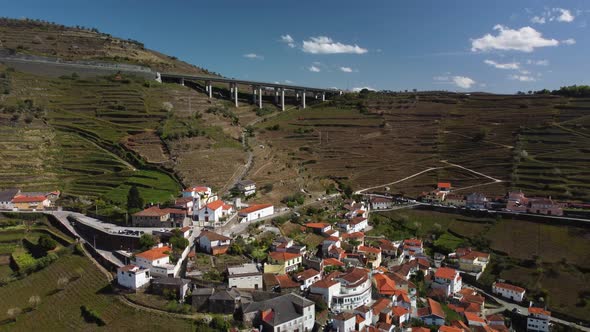 drone footage flying away from a beautiful village in the mountains near porto in portugal showing t alt