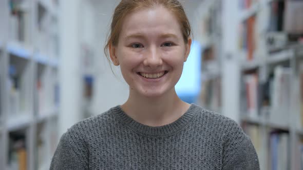 Portrait of Smiling Young Woman Looking at Camera in Cafe alt
