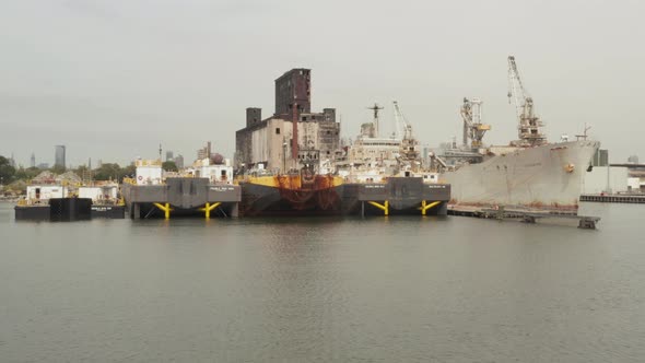 Towards Docks Rusty Old Cargo Ship and Warehouse in the Docks of New York City on a Cloudy alt