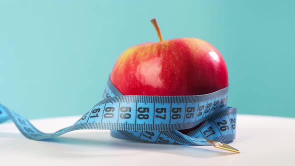 Healthy Green and Vegan Cocktail With Centimeter Tape on White Wooden Table alt