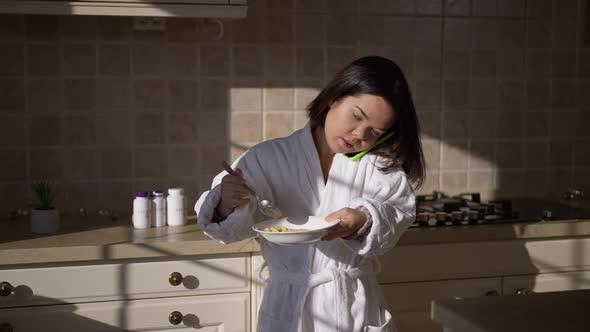 Hurrying Little Woman Entering Kitchen Eating Morning Cereals Leaving Talking on Phone alt