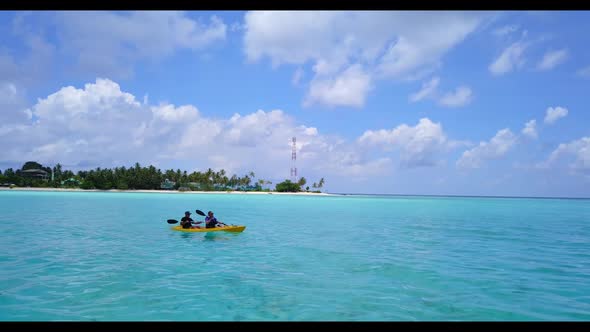 Man and woman sunbathing on relaxing lagoon beach time by blue ocean and white sand background of th alt