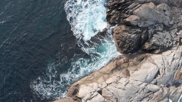 Coastal scenary with crashing waves on the rock 