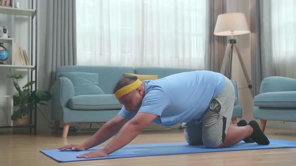 Fat Asian Man Doing Yoga By Upward Facing Forward Bend On Mat At Home alt